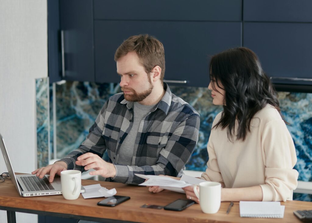 A couple checks hiddenhomecosts.com for finance tips for first time homebuyers.