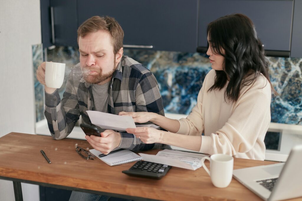 One spits out their coffee in shock as the other finds hidden closing costs.