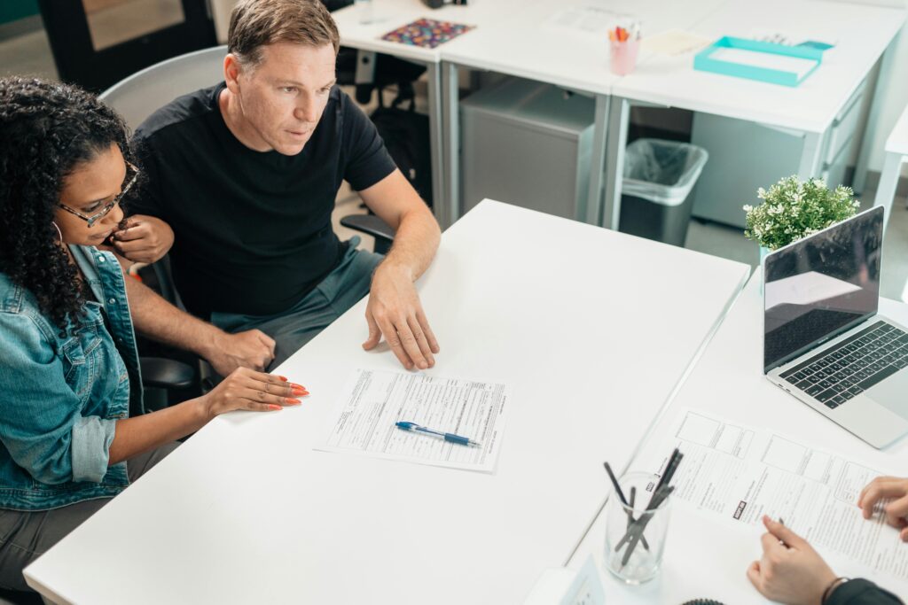 First time homebuyers discuss mortgage loan options with their financial advisor.