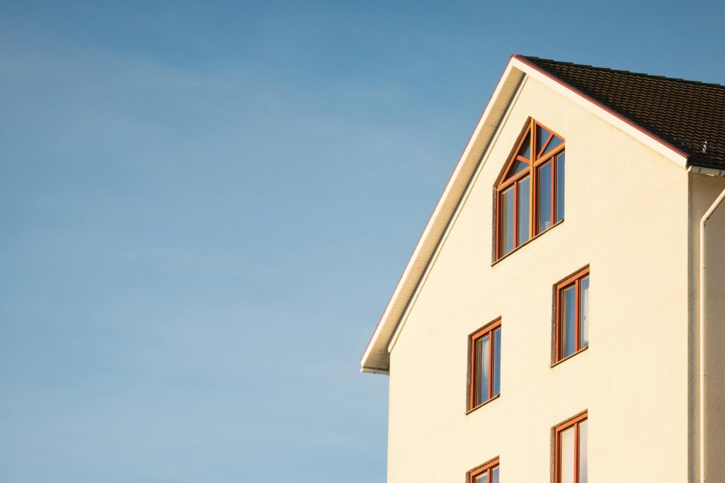 A home is silhouetted against a pale blue sky as it waits for funds to clear escrow and finalize its purchase