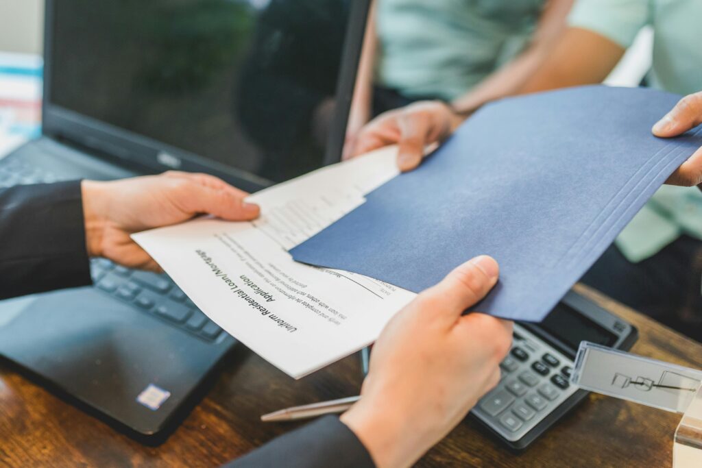 A first-time homebuyer receives mortgage options paperwork